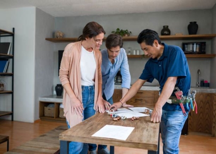 Plumber discussing details with homeowners
